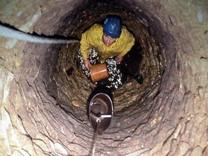 Pouring carbide in the sewage well